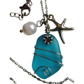 Light blue sea glass pendant on a metal delicate necklace 22 inches with a sea star and a plastic pearl