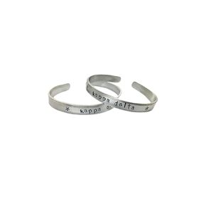 Kappa Delta Cuff Bracelet - handstamped in a whimsical font on a non tarnish aluminum cuff, officially licensed