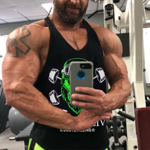 قمصان بدون أكمام للرجال من GYMAPE Stringer Gym لكمال الأجسام من القطن للتمرين مع حاشية مقوسة in Kuwait