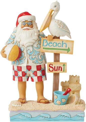 Enesco Jim Shore Heartwood Creek Coastal Santa with Beach Signs and Pelican Figurine- Stone Resin Hand Painted Crafted Collectible Santa Figurines Christmas Home Decor Statue, 9.45 Inch in Saudi Arabia