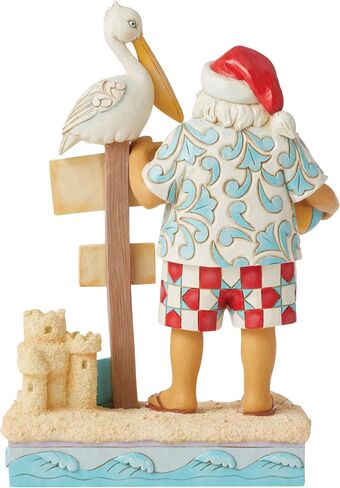 Enesco Jim Shore Heartwood Creek Coastal Santa with Beach Signs and Pelican Figurine- Stone Resin Hand Painted Crafted Collectible Santa Figurines Christmas Home Decor Statue, 9.45 Inch in Saudi Arabia