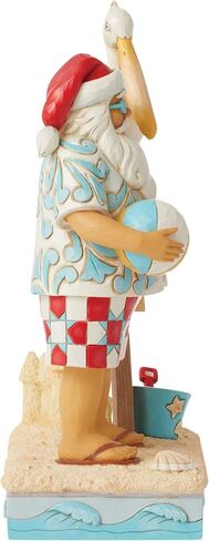 Enesco Jim Shore Heartwood Creek Coastal Santa with Beach Signs and Pelican Figurine- Stone Resin Hand Painted Crafted Collectible Santa Figurines Christmas Home Decor Statue, 9.45 Inch in Saudi Arabia