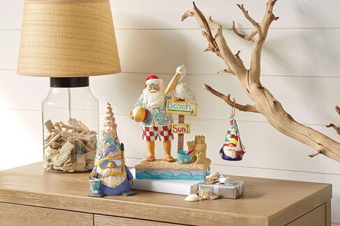 Enesco Jim Shore Heartwood Creek Coastal Santa with Beach Signs and Pelican Figurine- Stone Resin Hand Painted Crafted Collectible Santa Figurines Christmas Home Decor Statue, 9.45 Inch in Saudi Arabia