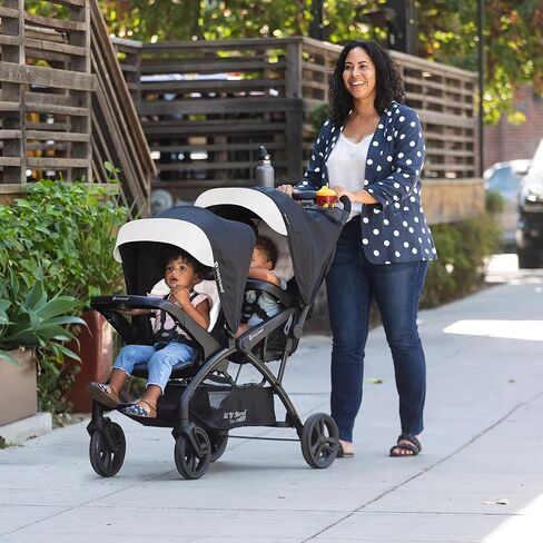 Baby Trend Sit N Stand Double Stroller 2.0 DLX with 5 Point Safety Harness, Canopy, Extra Basket, 2 Cup Holders, and Covered Compartment, Magnolia in Kuwait