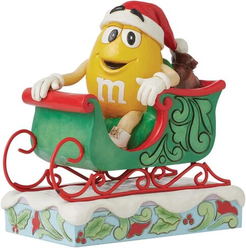 Enesco M&M's by Jim Shore M&M شخصية صفراء تركب في مزلقة - تمثال حلوى M&M مطلي يدويًا من الراتنج الحجري لديكور المنزل في عيد الميلاد، 5.71 بوصة in Saudi Arabia