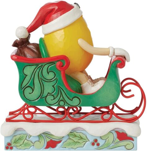 Enesco M&M's by Jim Shore M&M شخصية صفراء تركب في مزلقة - تمثال حلوى M&M مطلي يدويًا من الراتنج الحجري لديكور المنزل في عيد الميلاد، 5.71 بوصة in Saudi Arabia