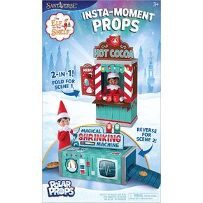 The Elf on the Shelf Insta-Props 2-in-1 Scene Kit with Reversible Pop Out Backdrop - Hot Cocoa Stand and Magic Shrinking Machine Scenes with Accessories