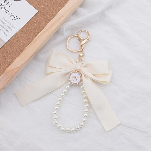 Pink Pearl Chain Bow Keychain for Women Girls White Pearl Keychain Wristlet for Purse Backpack Black Bow Charms in Saudi Arabia