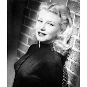 Ginger Rogers leaning on a brick wall Photo Print (8 x 10)