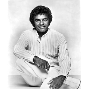 Johnny Mathis wearing a striped shirt Photo Print (8 x 10)