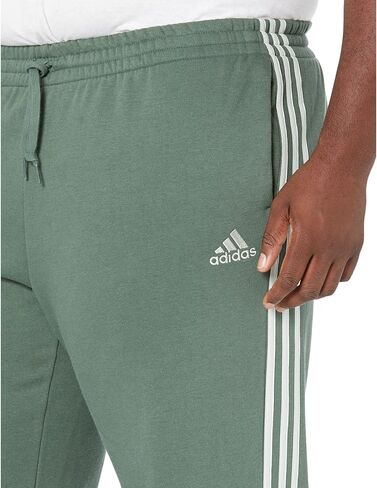 بنطال adidas Big & Tall Essentials مصنوع من الصوف بحاشية مفتوحة وثلاثة خطوط أخضر أكسيد/أخضر كتان XLT in Saudi Arabia