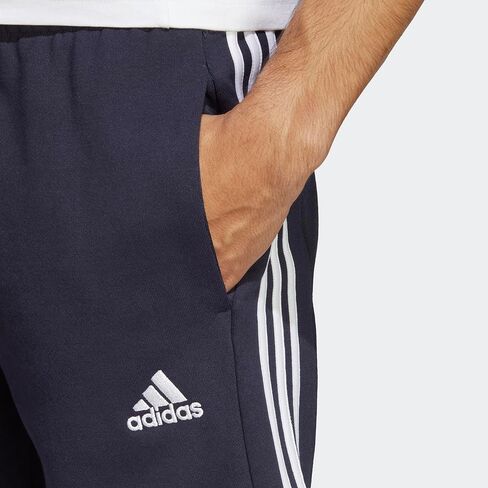 شورت رجالي من adidas مقاس Essentials French Terry 3-Stripes، مقاس متوسط ​​رمادي منقط، كبير/طويل in Saudi Arabia