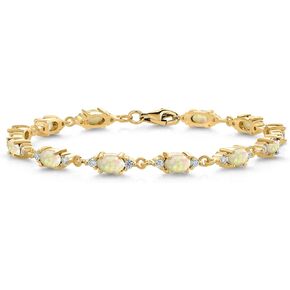 Gem Stone King 18K Yellow Gold Plated Silver White Ethiopian Opal and White Moissanite Tennis Bracelet For Women (4.75 Cttw, Gemstone Birthstone, Oval/Cabochon 6X4MM, 6.5 Inch)