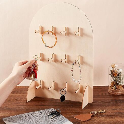 حامل عرض PH PandaHall Pegboard، حامل عرض سوار خشبي كبير على شكل قوس، حامل منظم المجوهرات على سطح الطاولة مع 12 خطافًا لبطاقات القرط، والقلائد، وسلاسل المفاتيح، وخشب Burlywood، 5.9x5.9x15.8 بوصة in Saudi Arabia