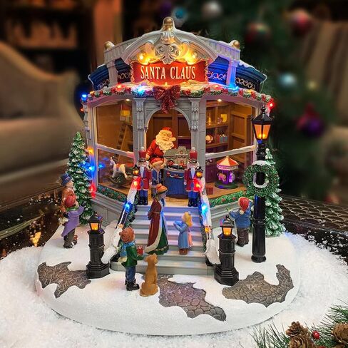 Christmas Village Building, Santa's Toy Shop with Christmas Music, LED Lights, and Animation - Power Adapter (Included) (15.35" H x 16.5" W x 15.2" D) by Moments in Time in Saudi Arabia