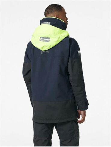 سترات Helly-Hansen Skagen المقاومة للماء للرجال تتميز بنسيج إبحار مقاوم للرياح وغطاء رأس أصفر نيون قابل للتعبئة، GOLD RUSH - متوسط in Saudi Arabia