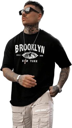 تي شيرت رجالي من SweatyRocks برسوم جرافيك وأكمام قصيرة ورقبة دائرية وكتف منسدل in Kuwait