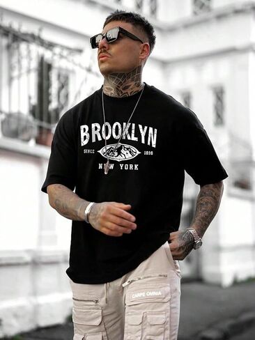 تي شيرت رجالي من SweatyRocks برسوم جرافيك وأكمام قصيرة ورقبة دائرية وكتف منسدل in Kuwait