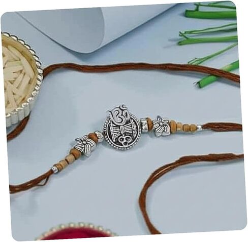 أنا جودوال يتوهم Om & Trishul Design Rakhi مع بطاقة Rakshabandhan لإخوانه/Brother/Bhai (R374BR) in Saudi Arabia