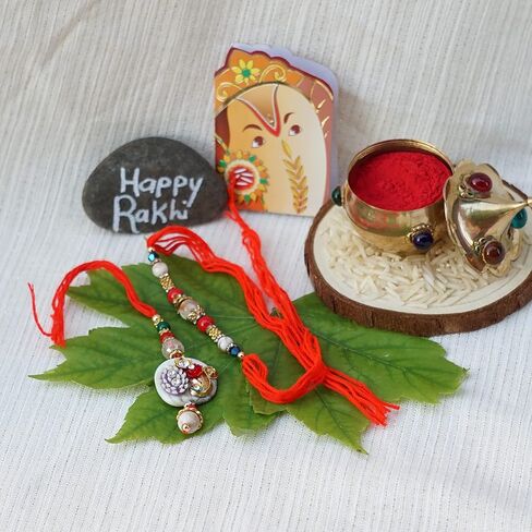 Rakhi Gift Box with Bhaiya Bhabhi Rakhi Set made of Floral Motif, Beads, includes Roli, Chawal, Raksha Bandhan Card, Thali Set, and Chocolate (Elegant Couple Rakhi) in Kuwait