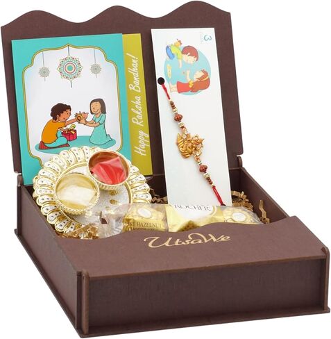 UtsaWe Rakhi Gift Box | Rakhi Gift Hamper made with a Divine Laxmiji Rakhi, Roli, Chaval, Mini Thali Set, Greeting Card, and Chocolates | Rakhi Gift Set | Brother Rakhi | Rakhi Bracelet Hamper (Laxmiji Rakhi) in Kuwait