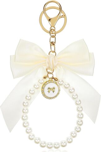 Bow keychain ، beige keychain keychain coquette keychains cute bow pres bag bag charm keychains bows key kins wistlet accessories bows for women car car base bas in Kuwait