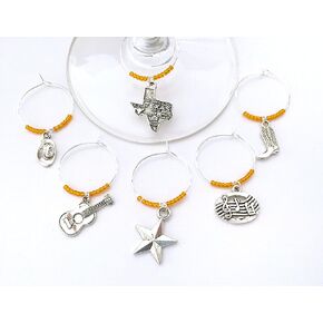 Austin Texas Wine Charms. Inspired by Austin Music and Country scene. Charms include Texas Charm, Guitar, Cowboy Hat, Cowboy Boots, Music Notes, and Texas Star. Set of 6. ORANGE BEADS.