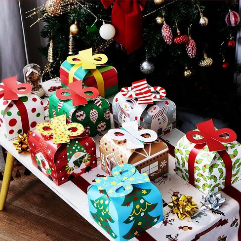 JOYIN 24 PCS 3D Christmas Goody Gift Boxes with Bow for Holiday Xmas Goodie Paper Boxes, School Classroom Party Favor Supply, 6" x 6" x 5.5" 8 Designs Candy Treat Cardboard Cookie Box for Gift Giving in Saudi Arabia