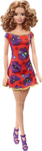 Barbie GBK92 Doll ، امرأة سمراء Auburn Curly Light ترتدي فستان أزهار أحمر وأرجواني in Saudi Arabia