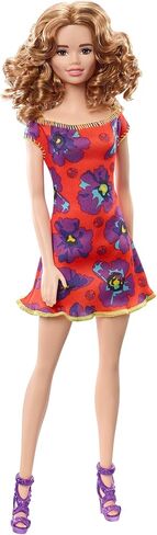 Barbie GBK92 Doll ، امرأة سمراء Auburn Curly Light ترتدي فستان أزهار أحمر وأرجواني in Saudi Arabia