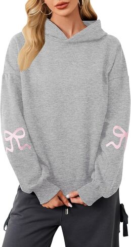 سترة نسائية بغطاء للرأس مطبوعة بفيونكة كبيرة الحجم ومزودة بغطاء للرأس وأكمام طويلة ورسومات لطيفة وكتف منسدل in Kuwait