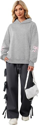 سترة نسائية بغطاء للرأس مطبوعة بفيونكة كبيرة الحجم ومزودة بغطاء للرأس وأكمام طويلة ورسومات لطيفة وكتف منسدل in Kuwait