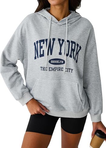 سويت شيرت Avanova نسائي بغطاء للرأس برسوم جرافيك نيويورك وأكمام طويلة برباط كبير مع جيب كانجارو in Kuwait