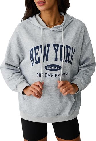 سويت شيرت Avanova نسائي بغطاء للرأس برسوم جرافيك نيويورك وأكمام طويلة برباط كبير مع جيب كانجارو in Kuwait