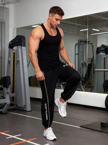 OYOANGLE Men's Graphic Workout Pants Drawstring Waist Fitness Trousers Loose Fit Gym Running Breathable Sweatpants in Saudi Arabia